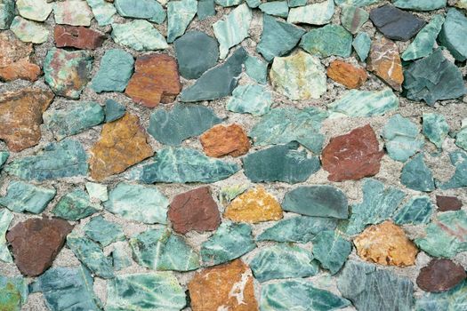 Multi-colored pebbles lie on the sandy beach. Close-up. High quality photo