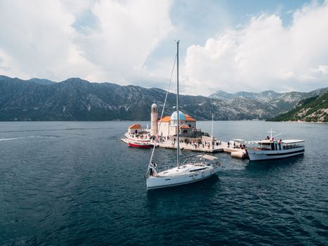 Boats off the island of Gospa od Skrpjela in the Kotor Bay. Montenegro. High quality photo