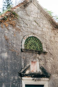 Old stone wall of a building with an arched window. Perast, Montenegro. High quality photo