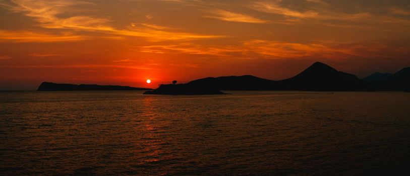 Red sunset over Mamula island. Montenegro. High quality photo