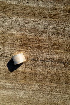 Aerial photographic documentation of a field with round bales in the summer season