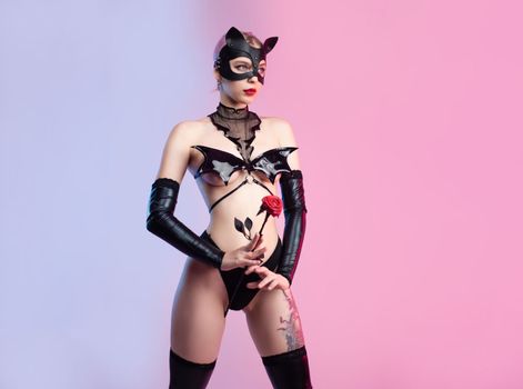 Sexy girl in underwear bdsm leather mask sex games costume on pink bright background copy paste