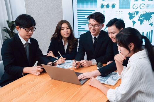 Business team of financial data analysis meeting with business intelligence, report paper and dashboard on laptop for marketing strategy. Business people working together to promote harmony in office.