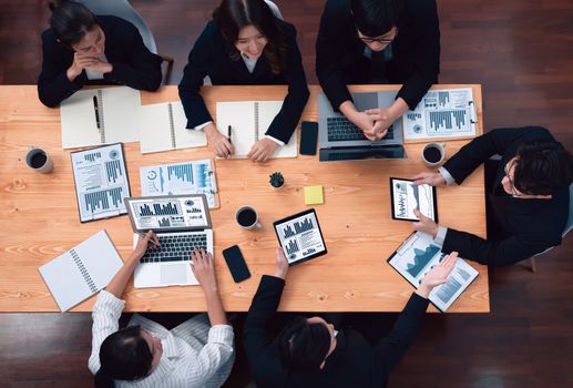 Top-view business team of financial data analysis meeting with business intelligence, report paper and dashboard on laptop for marketing strategy. Business people working together in office of harmony