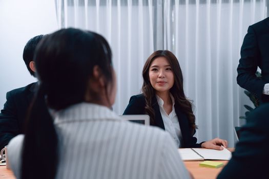 Business team of financial data analysis meeting with business intelligence, report paper and dashboard on laptop for marketing strategy. Business people working together to promote harmony in office.