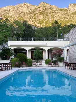 Pool in the courtyard of the house at the foot of the mountains. High quality photo