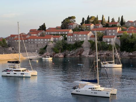 White catamarans moored off the island of Sveti Stefan. Montenegro. High quality photo