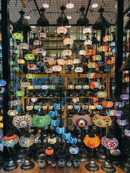 Multi-colored lamps and light fixtures hang on shelves in a supermarket. High quality photo