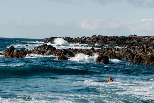 Waves of the Atlantic Ocean break on coastal rocks.