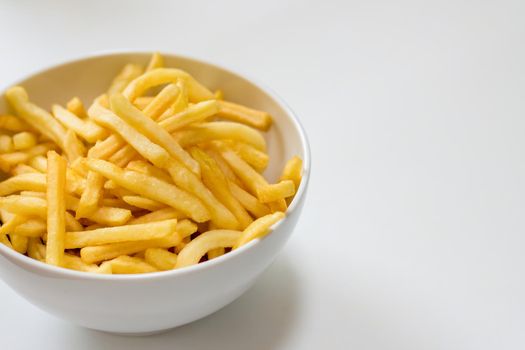 Full bowl of french fries on a white background