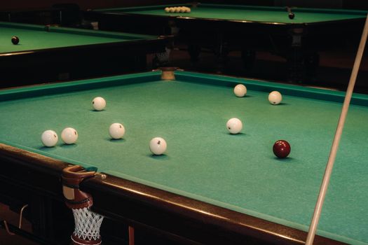 Billiard table with green surface and balls in the billiard club.Pool Game.