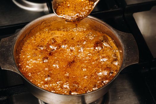 Preparation of sugar candies at home.A taste of our childhood.Rooster lollipops.Boiling Sugar caramel.