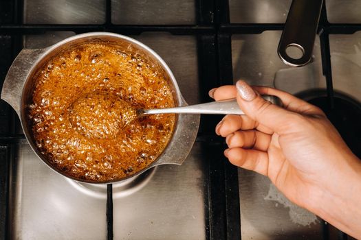 Preparation of sugar candies at home.A taste of our childhood.Rooster lollipops.Boiling Sugar caramel.