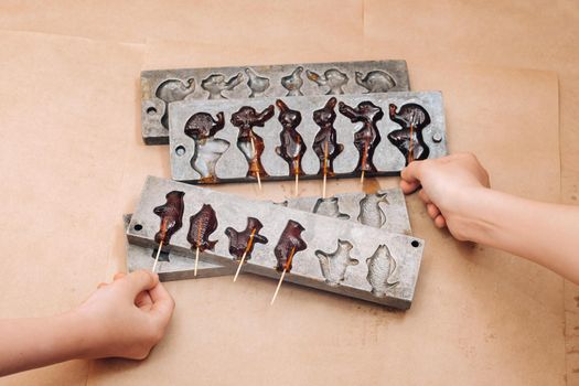 Making sugar lollipops at home.A taste of our childhood.Cockerel lollipops on a stick.Sugar caramel.