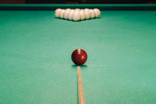Start of the game of billiards on the green table.The balls are arranged in a triangle on the table.