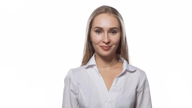 Beautiful young woman with long straight blond hair looking at the camera wearing white medical uniform isolated on white background.