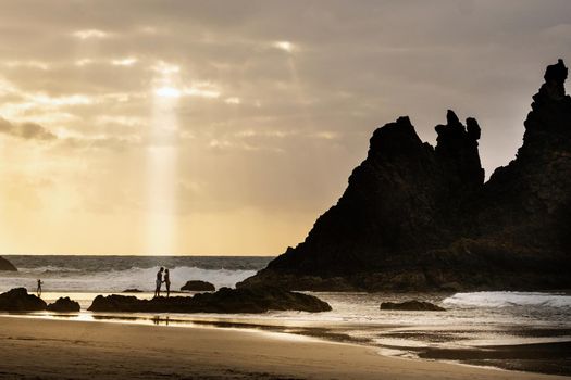 A couple of lovers on the sandy beach of Benijo on the island of Tenerife.Spain .