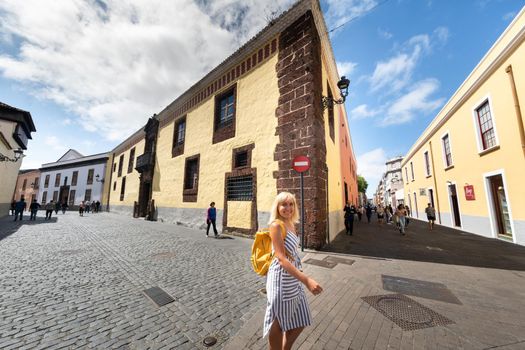 A girl in a striped dress walks through the Old Town center of La Laguna in Tenerife, Canary Islands, Spain.