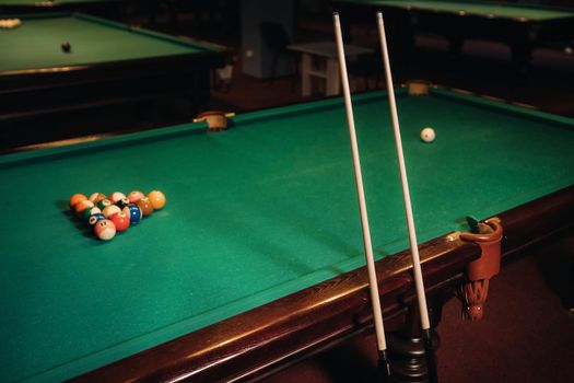 Billiard table with green surface and balls in the billiard club.Pool Game.