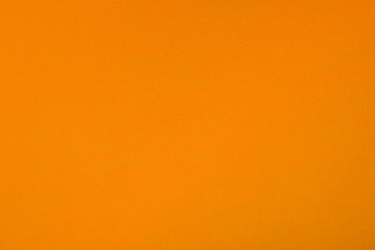 Orange background with paper texture, horizontal, blank space.