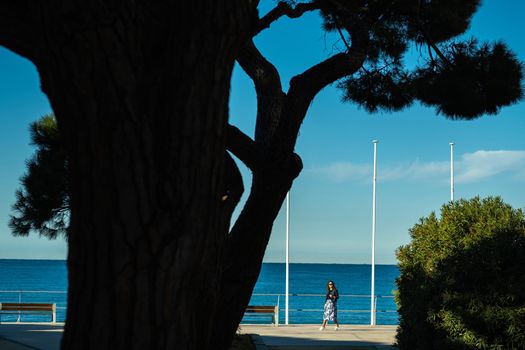 Portrait of a girl in a skirt on the Mediterranean embankment of the village of Saint-Cyr-sur-Mer, France.