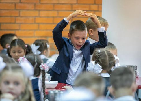 First graders eat in the school cafeteria. Lunch in the dining room on September 1st. Moscow, Russia, September 2, 2019