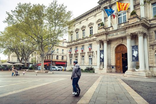 Avignon, France-April 6, 2019: Old Town Street and Hotel de Ville in the center of Avignon.