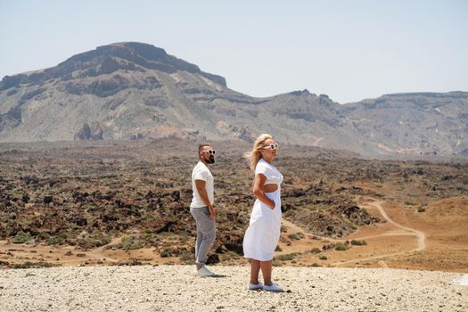 A couple in love stands in the crater of the Teide volcano.Tenerife, Canary Islands.