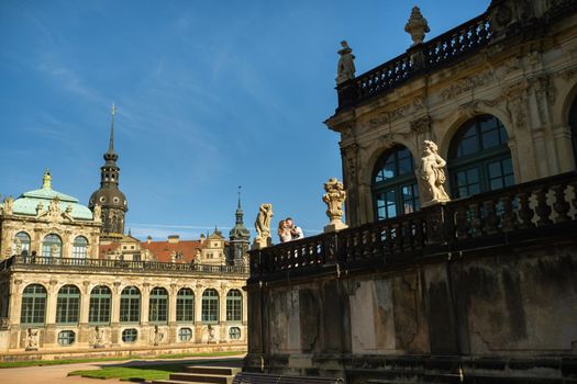 A couple in love on a wedding walk at the famous Baroque Zwinger Palace in Dresden, Saxony, Germany.