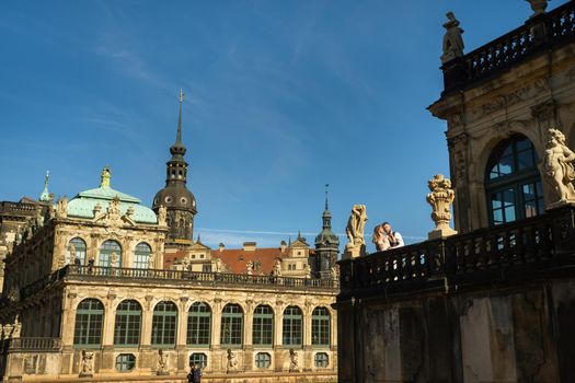 A couple in love on a wedding walk at the famous Baroque Zwinger Palace in Dresden, Saxony, Germany.