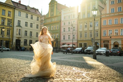 A bride in a wedding dress with long hair in the old town of Wroclaw. Wedding photo shoot in the center of an ancient city in Poland.Wroclaw, Poland.