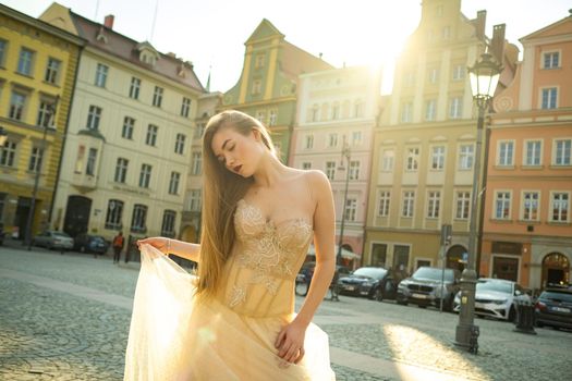 A bride in a wedding dress with long hair in the old town of Wroclaw. Wedding photo shoot in the center of an ancient city in Poland.Wroclaw, Poland.