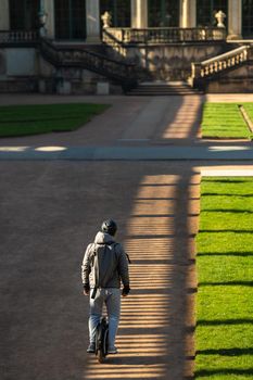 A man on a monowheel rides through the sights of Dresden, Saxon Switzerland, Germany:.