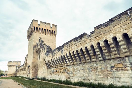 The fortress wall near the Palace of the Popes in the old town of Avignon.France.