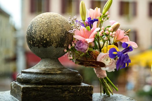a wedding bouquet with lilies stands on the street in rainy weather.Wedding Decor.