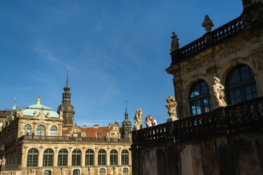 A couple in love on a wedding walk at the famous Baroque Zwinger Palace in Dresden, Saxony, Germany.