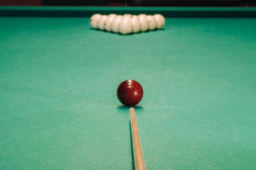 Start of the game of billiards on the green table.The balls are arranged in a triangle on the table.