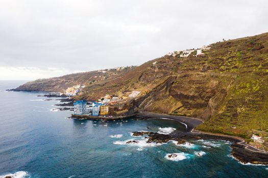 Rough rocky cliffs in the North of Tenerife.Black beach in the Canary Islands. Rocks, volcanic rocks, Atlantic ocean.