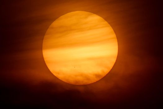 The sun and the sun set off behind the clouds