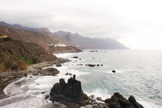 Rough rocky cliffs in the North of Tenerife. Beautiful Benijo beach in the Canary Islands. Rocks, volcanic rocks, Atlantic ocean.