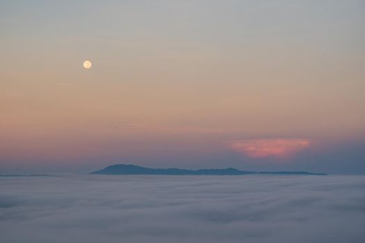 Full moon falling And the mist in the morning time. The color orange sky reflects the sun's rays.