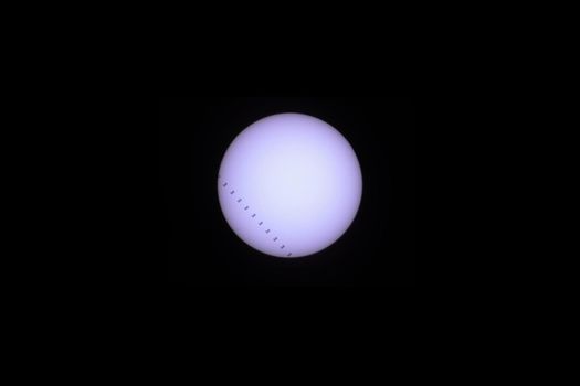 Telescopic view of the Sun as the International Space Station (ISS) transits . 11 frame composit
