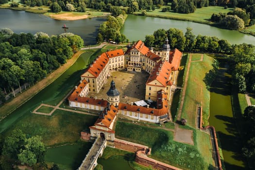 Aerial photo Nesvizh castle in autumn evening, Belarus Minsk, top view.