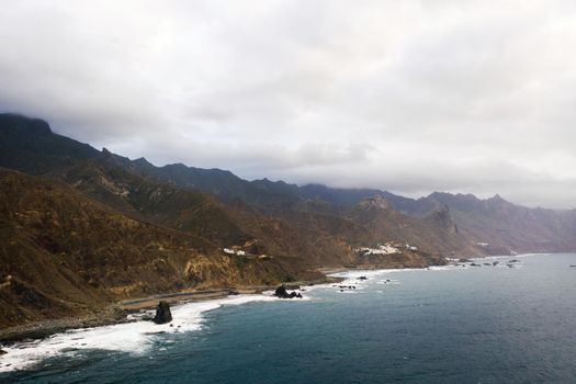 Rough rocky cliffs in the North of Tenerife. Beautiful Benijo beach in the Canary Islands. Rocks, volcanic rocks, Atlantic ocean.