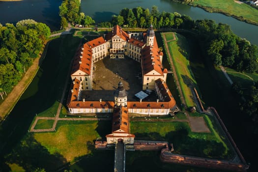 Aerial photo Nesvizh castle in autumn evening, Belarus Minsk, top view.