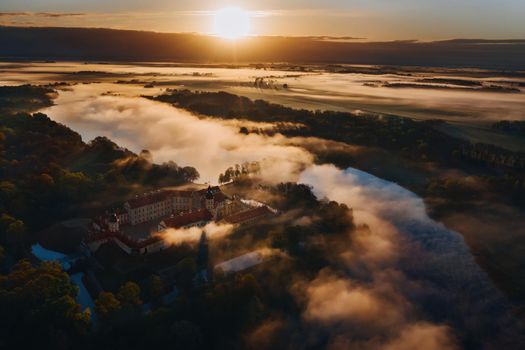 Foggy dawn in Nesvizh.View from the height of the Nesvizh castle and Park at dawn.Misty dawn.