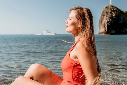 Sexy young woman in stylish bikini lying on seashore, closeup. Holiday, vacation and recreational concept.