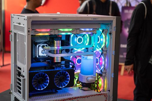 shot of overclocked CPU computer cabinet with water liquid cooled processors and RGB red green blue lighting with metal pipes running India