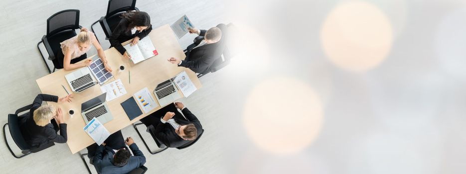 Business people group meeting shot from top widen view in office . Profession businesswomen, businessmen and office workers working in team conference with project planning document on meeting table .