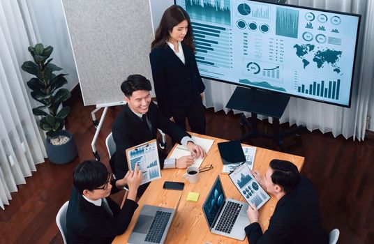 Top widen view of confidence of company presentation on financial analyzed by business intelligence in dashboard report with businesspeople in boardroom meeting to promote harmony in workplace concept